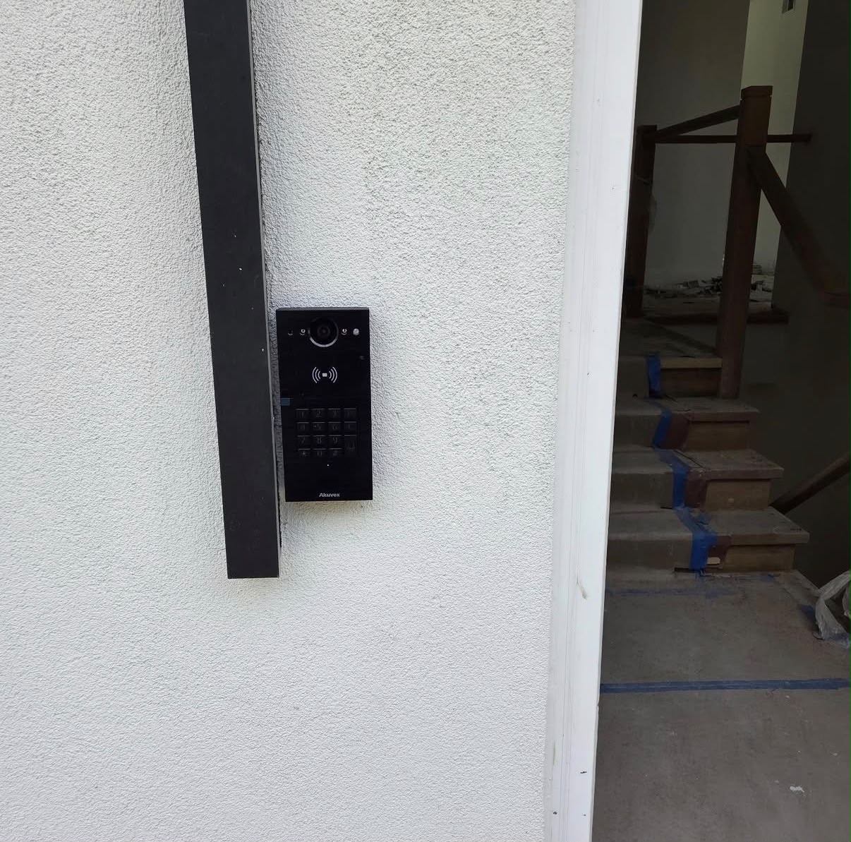 Video intercom keypad panel installed on a stone entry column